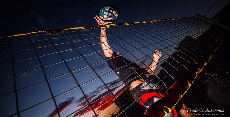 Beach volley player smashing ball